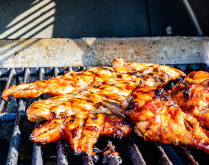 BBQ sauced Chicken legs and breasts on the grill. Calgary, Alberta, Canada