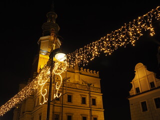 Illuminated Christmas installations on the market square in Poznań. Night lights of the city.
