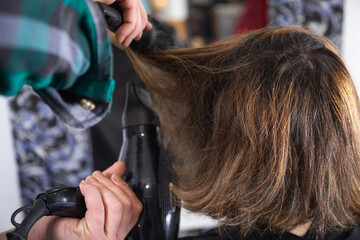 hairdresser stylist drying and styling wet hair