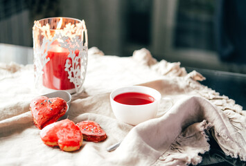 Obraz na płótnie Canvas Heart shaped red hand made cookies and hibiscus tea.