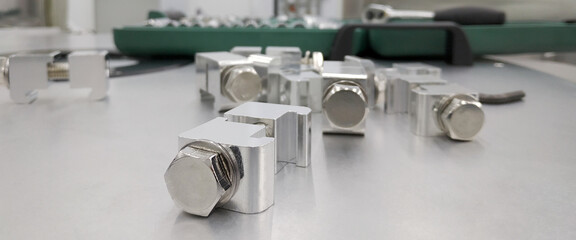 Macro photo of chromed screws on a white background. Macro photo chromed screws, screw background, steel screw, selective focus.