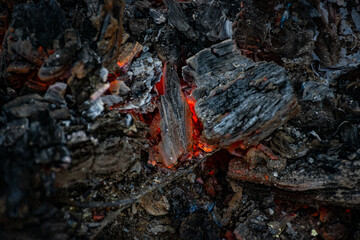Burning coals at night, rotting coal, barbecue season. Close-up.