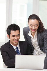 Group of businesspeople discussing working on computer