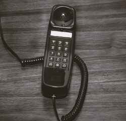 Old analog telephone with numerical push buttons.