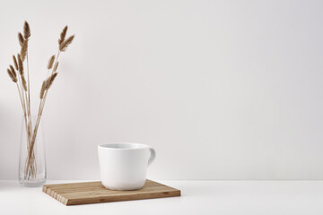 Transparent vase and mug on a white background. Minimalism. Copy space, mock up