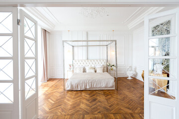 Fototapeta na wymiar modern interior of a luxurious large bright two-room apartment. white walls, luxurious expensive furniture, parquet flooring and white interior doors