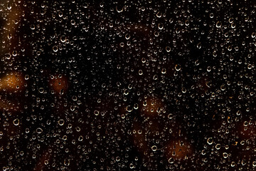 Fototapeta premium Raindrops on glass. Night rain