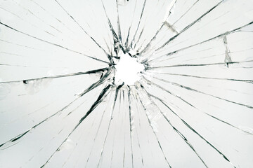 The hole in the broken and cracked glass, closeup