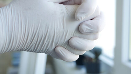 Image with Doctor Hands Wearing Surgical Gloves Needed in Protection Against Coronavirus Contamination