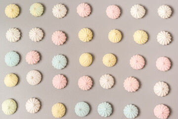 Sugar protein dessert in pastel colors on gray background. Meringues. The view from the top