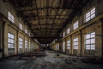Abandoned factory. Large empty industrial hall with garbage