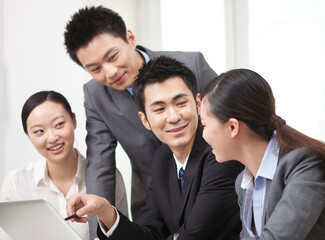 Group of businesspeople discussing working on computer