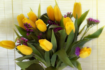 bouquet of yellow tulips on wooden background