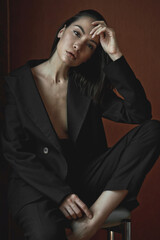 Fototapeta premium Beautiful young woman in black suit