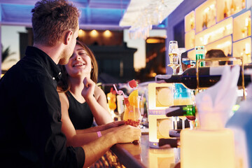At the bar. Happy young couple is together on their vacation