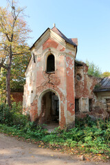 old ruined abandoned red brick building in autumn forest