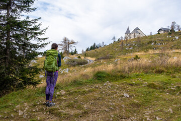Woman hiker looking at Urslja gora or Plesivec in the Koroska region of Slovenia