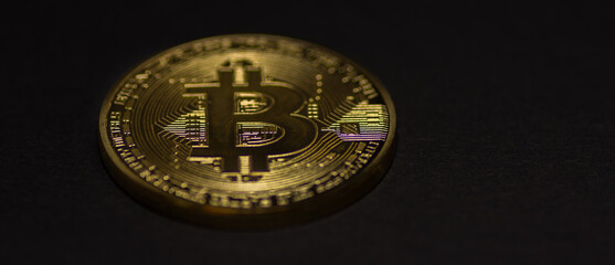 single golden valuable bitcoin on black background panorama