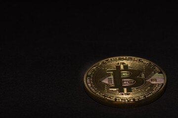 single golden valuable bitcoin on black background right bottom