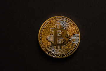 single golden shiny valuable bitcoin front view with black middle