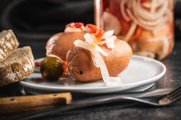 Pickled sausages with onion and red pepper. Marinated food.