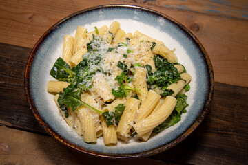 A delicious plate of Pasta with peas and herbs tops off with grated cheese.