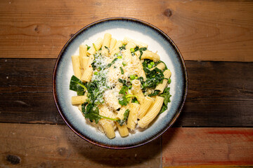 A delicious plate of Pasta with peas and herbs tops off with grated cheese.