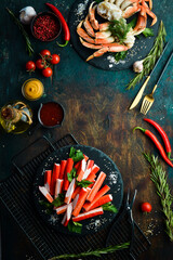 Crab sticks from a crab on a black stone plate. Rustic style. Seafood delicacies.