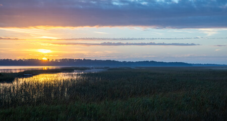 Fototapeta na wymiar Sunrise over the salt marsh along the intracoastal waterway. 