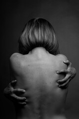 Black and white photo of a nude female back.