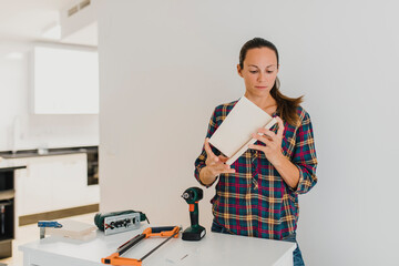 Mid adult woman doing DIY work while standing at home