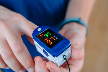 Pulse Oximeter On a male finger. Man using Oximeter. Healthy Concept