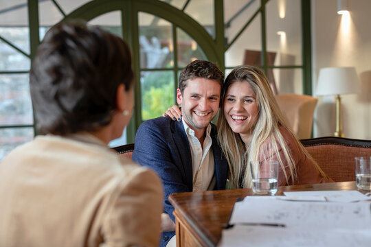 Smiling couple in meeting with female event planner in her studio - Powered by Adobe