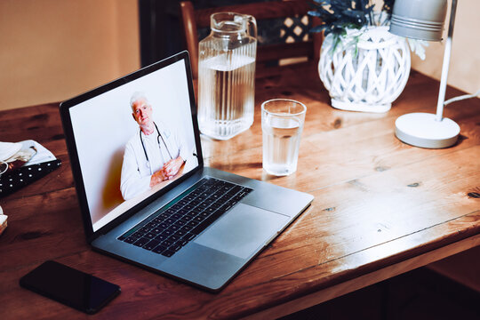 Video call with doctor on laptop at home during COVID-19