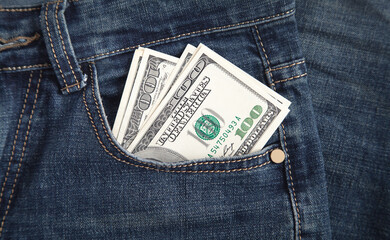 Dollar banknotes in jeans pocket.