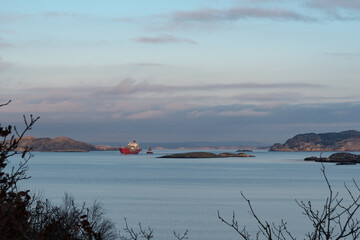 Towing of ships in perfectly calm weather with a nice sunset in progress