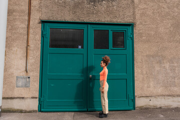 Young woman standing straight on footpath