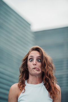 Woman showing weird facial expression while standing outdoors