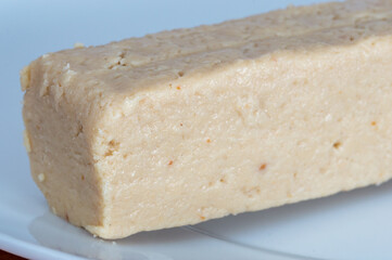 Close-up on sesame halva on white plate.
