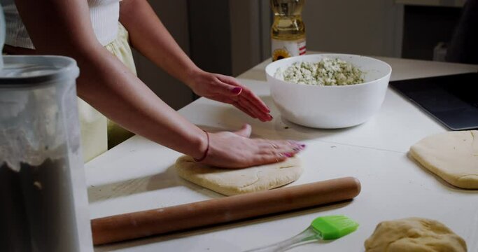 A slow motion frame of how a woman prepares dough in the kitchen at home.