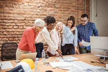 Shot of a group of businesspeople sitting together in a meeting. Group of business persons in...