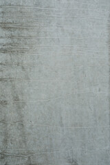 Fototapeta premium Grey cement wall with abstract surface, empty wall for a banner or background, space for text no person and vertical format