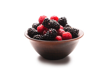 Raspberry, blackberry and mint leaf in ceramic brown bowl isolated on white