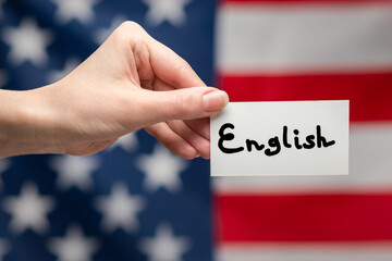 English text on a card. American flag background.