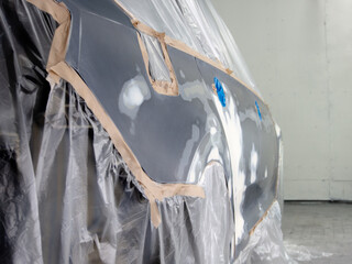 car prepared for painting in a spray booth.