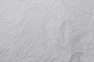 Crumpled white paper background.
