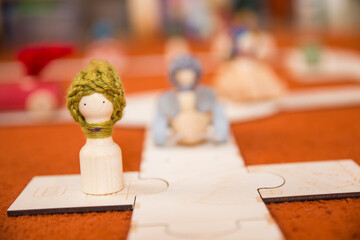 Hands of a child playing with wooden toys at home. Colorful interior of a children's room.