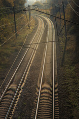 Fototapeta na wymiar Double-track electrified railroad in sunset or dawn light
