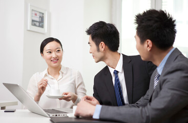 Group of business people chatting in office