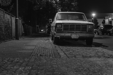 Front view of an old pickup truck at night, Parking pickup truck at night, BLACK AND WHITE PHOTO